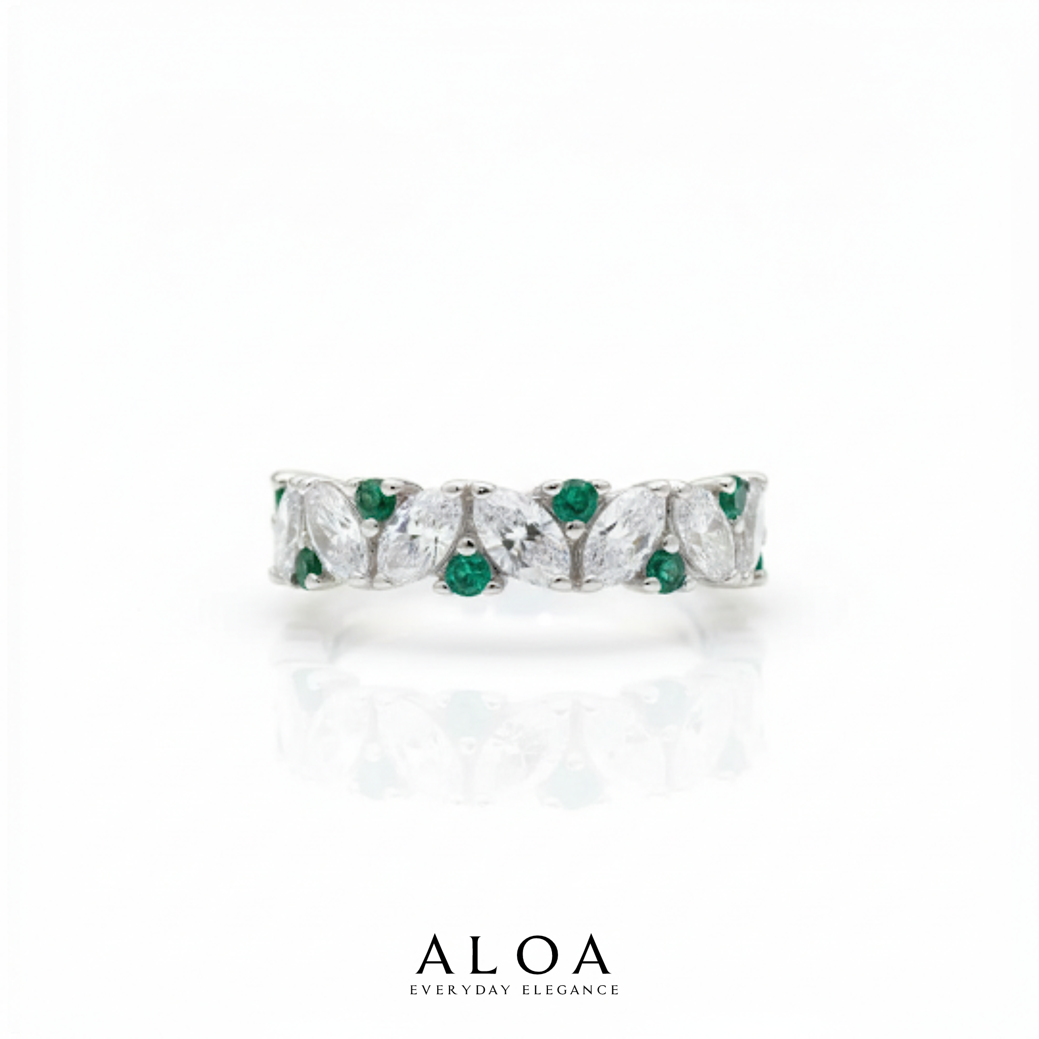 Elegant ring with emerald and diamond accents on a white background, featuring the brand 'ALOA'.